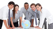 Photo: Portrait of business team around a terrestrial globe Portrait of business team around a terrestrial globe