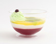 Multilayer jelly with slices of  kiwi  in transparent bowl