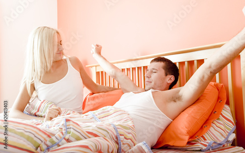 Photo: Couple Waking Up in Bed Couple Waking Up in Bed