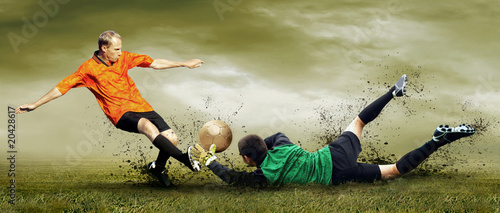 Photo: Shoot of football player and goalkeeper on the outdoors field Shoot of football player and goalkeeper on the outdoors field