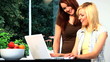 Beautiful blonde & brunette girls use a laptop computer at home Beautiful blonde & brunette girls use a laptop computer at home