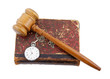 Judge's gavel and very old legal book with watch