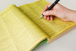 Photo: Search yellow pages with hand and pen Search yellow pages with hand and pen