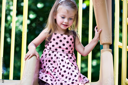 Photo: Little Girl Playing at the Playground Little Girl Playing at the Playground