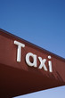 Photo: Taxi Sign On a Brown Wall Taxi Sign On a Brown Wall