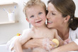 Mother giving baby boy a bath
