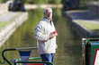 Man drinking coffee on boat in canal