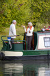Woman gesturing to man on boat in canal