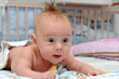 Happy baby crawling in bed