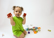Petite fille à genoux jouant aux cubes Petite fille à genoux jouant aux cubes