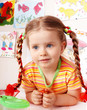 Child with chalk draw in playroom.