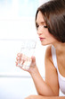 girl  holds a glass of pure fresh water