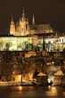 Snowy Prague gothic Castle with Charles Bridge in the Night Snowy Prague gothic Castle with Charles Bridge in the Night