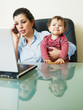 businesswoman on the phone, holding daughter