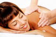Foto: Close-up of a beautiful smiling woman getting a massage. Close-up of a beautiful smiling woman getting a massage.