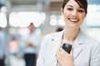 Cute smiling business female holding a cell phone