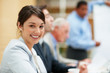 Happy business woman with coworker working at the back