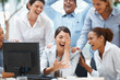 Business team laughing at a funny email on the computer