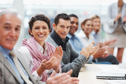 Photo : Successful business executive applauding at a conference Successful business executive applauding at a conference