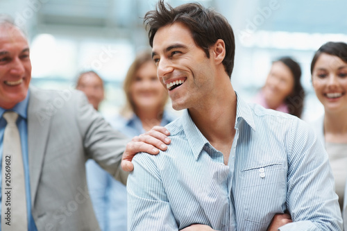 Photo: A young business executive enjoying success with team A young business executive enjoying success with team