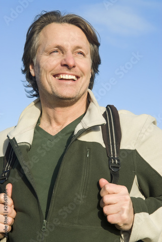 Photo: happy smiling outdoor man carrying rucksack happy smiling outdoor man carrying rucksack