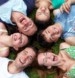 Photo: Young guys and girls lying on grass looking up Young guys and girls lying on grass looking up