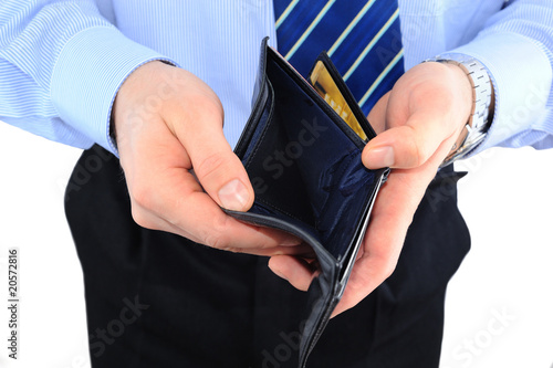 Photo: Businessman well-dressed with empry wallet isolated over white Businessman well-dressed with empry wallet isolated over white