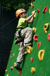 child climbing on a wall in an outdoor climbing center