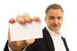 Mature businessman holds a blank business card in his hand Mature businessman holds a blank business card in his hand