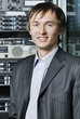 Portrait of young data center specialist in front of equipment Portrait of young data center specialist in front of equipment