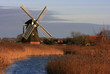 Dutch windmill at water and reeds