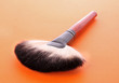 cosmetic brush on the orange background cosmetic brush on the orange background
