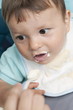 Young woman's hand feeding baby boy