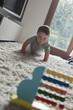 Baby boy crawling toward abacus Baby boy crawling toward abacus