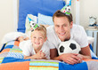 Happy child and his father playing with a soccer ball