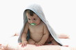 Baby boy wrapped in towel with pacifier