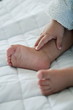 Closeup of baby's feet and hand
