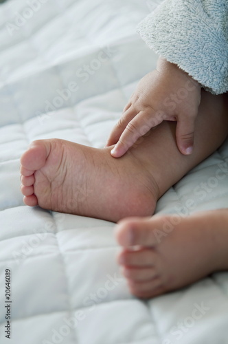 Photo: Closeup of baby's feet and hand Closeup of baby's feet and hand