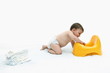 Baby boy with diapers and potty