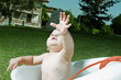 Baby boy taking bath in tub in garden