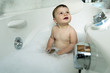 Baby boy taking bath in tub