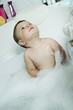 Baby boy taking bath in tub