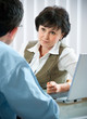 Photo: mid-adult man meeting with agent or advisor mid-adult man meeting with agent or advisor