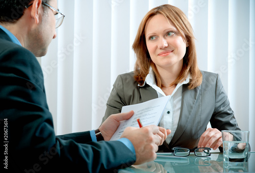 Photo: Young woman having a job interview in a office Young woman having a job interview in a office