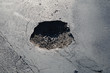 pothole in a road pothole in a road