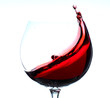 moving red wine glass over a white background