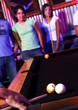 Young adults at a nightclub playing pool