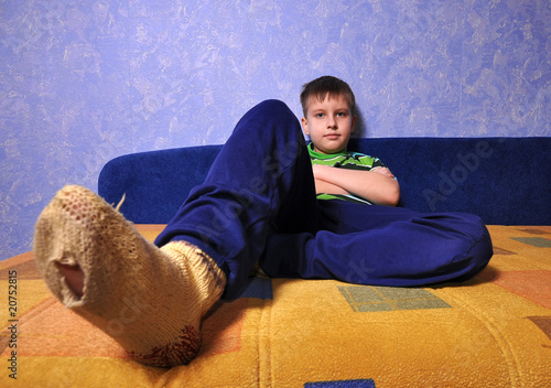 Photo: Boy wearing socks with holes in them Boy wearing socks with holes in them