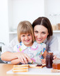 Cute little girl and her mother preparing toasts