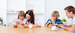 Merry family eating breakfast in the kitchen